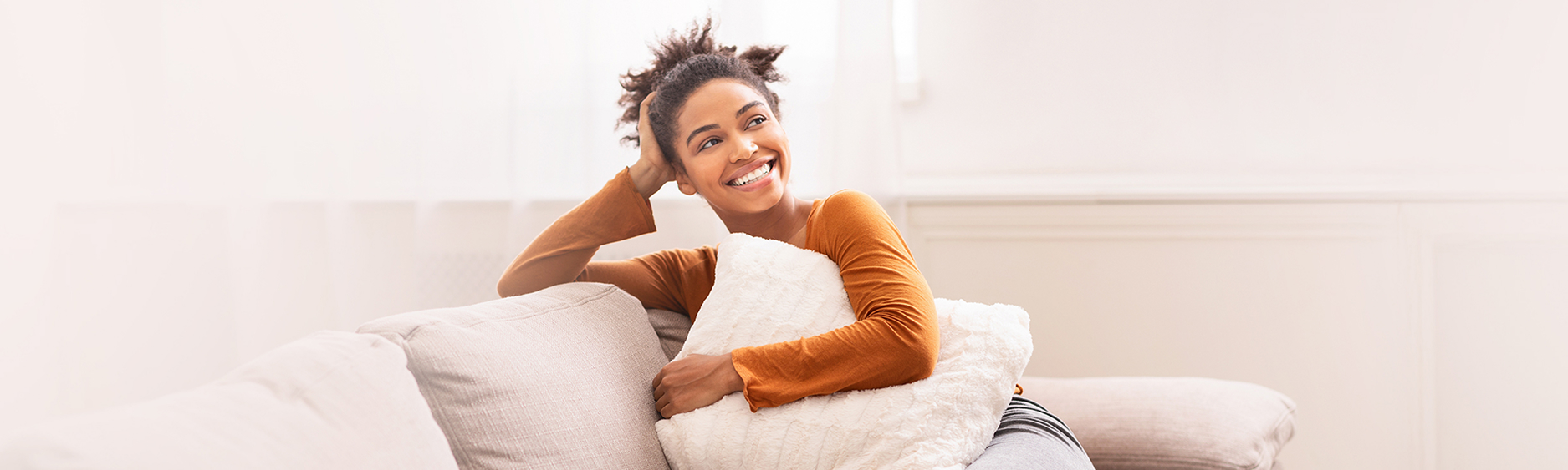 Woman sitting on sofa smiling